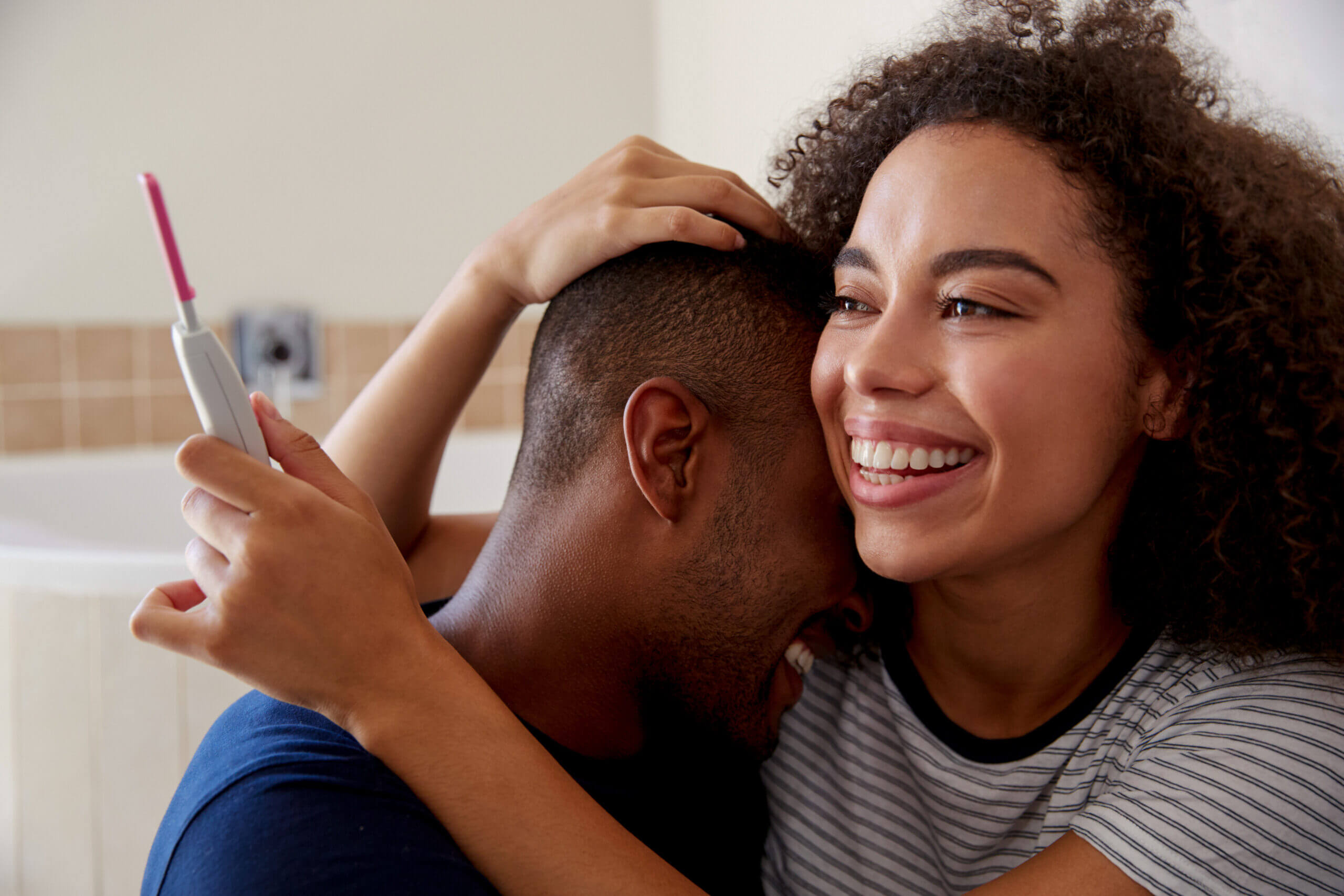 Couple celebrating positive pregnancy test — Life IVF Center