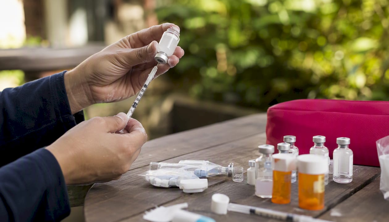 Hands preparing medications for DuoStim IVF protocol