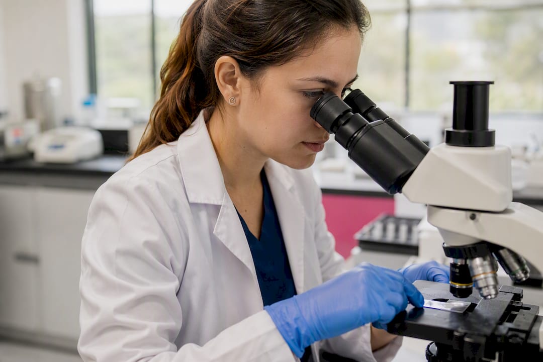 Lab technician handling uterine cell slide