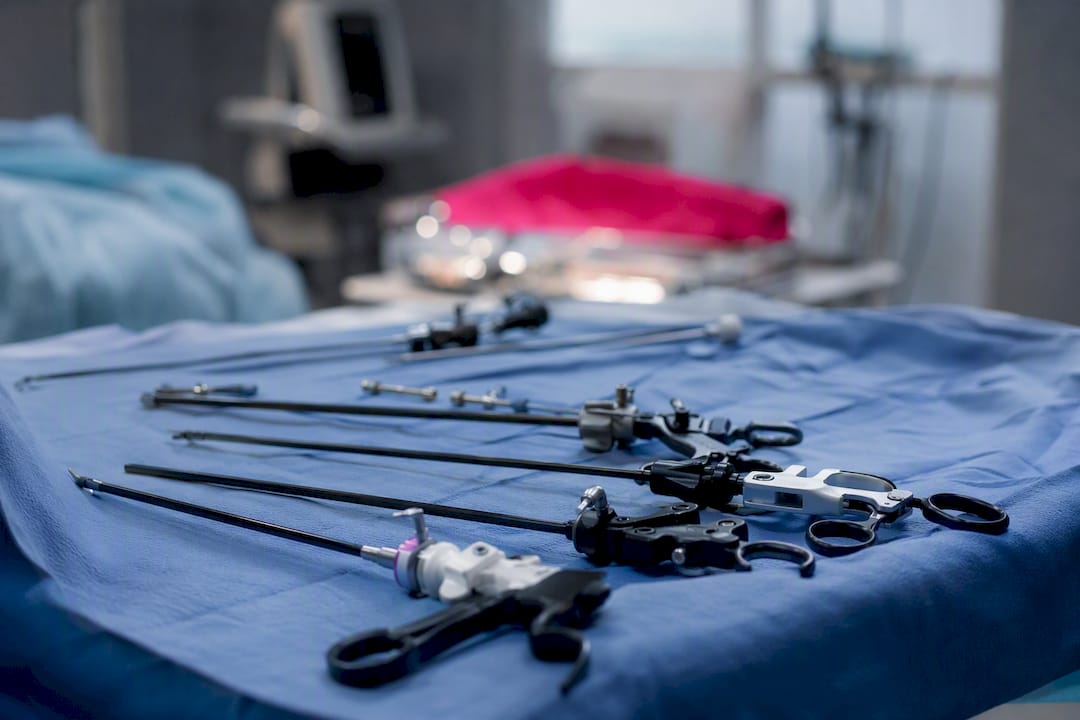 Close-up of laparoscopic surgery instruments on sterile tray