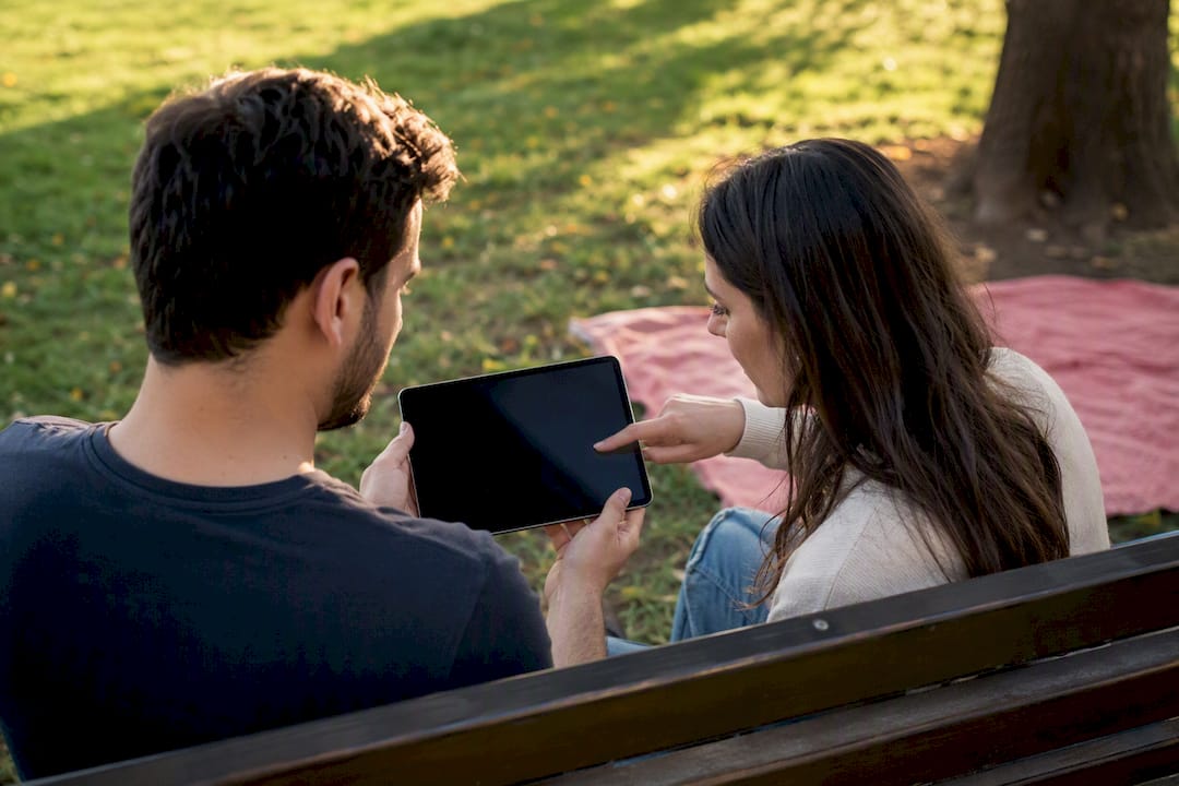 Couple reviewing sperm donor genetic information tablet