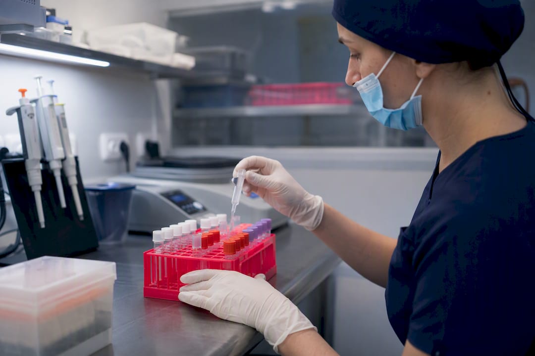 Lab technician pipetting sperm infectious disease sample